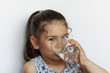 © kaganskaya115 - Cute little girl holding glass of water. and Child drinking water.