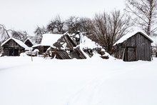 Snow-covered Old Abandoned Courtyard In Village