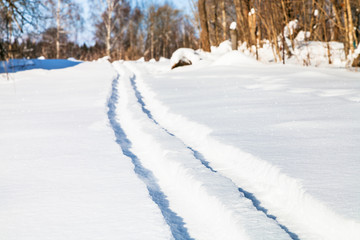 Sticker - ski track on snow field in sunny winter day