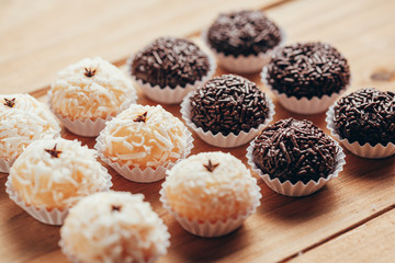 Handmade brazilian sweets: Beijinho and Brigadeiro. Common in children birthday party. Macro, close up