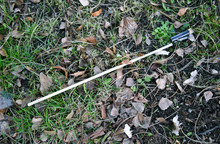 New Year’s Eve Trash: Wooden Rocket Stick With Burned Out Rocket Engine Tube On The Grass
