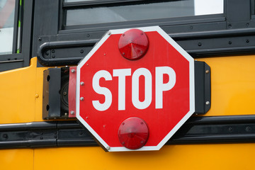 close up on stop sign on the school bus