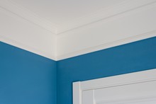 Details In The Interior. Ceiling Moldings, Blue Painted Walls, White Door