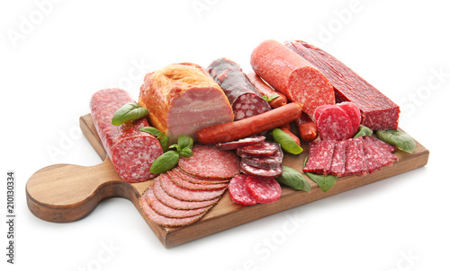 Assortment of delicious deli meats on wooden board, isolated on white Fotobehang