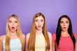 WTF! Portrait of shocked astonished trio with wide open mouth eyes and long hair looking at camera isolated on violet background