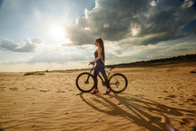 Active Life. Sport Girl With A Bike Enjoys The View Of Sunset. Heathy Lifestyle Concept