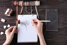 Woman Drawing Beautiful Rose On Sketch Pad