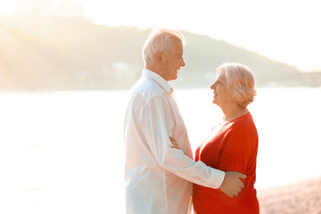 Wall Mural - Happy mature couple on riverside