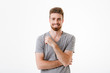 © Drobot Dean - Handsome young man standing isolated smiling