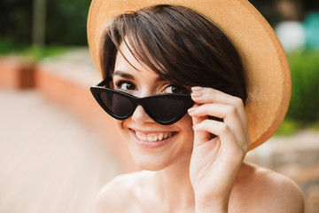 Wall Mural - Close up of a smiling young girl in summer hat