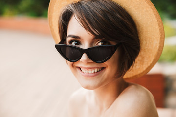 Wall Mural - Close up of a lovely young girl in summer hat