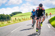 © Duncan Andison - Cyclists racing on country roads on a sunny day in the UK.