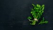 Fresh parsley. On a black wooden background. Top view. Copy space.