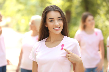 Canvas Print - Beautiful woman with pink ribbon outdoors. Breast cancer concept