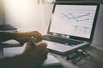 Poster - Professional at work, businessman writing report and using laptop working analysis investment connection at modern workplace