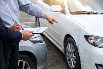 Wall Mural - Insurance Agent examine Damaged Car and filing Report Claim Form after accident, Traffic Accident and insurance concept