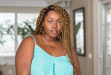 Poster - African american woman at home afraid and shocked with surprise expression, fear and excited face.