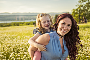 Wall Mural - Mother spending time with daughter during the sunset.