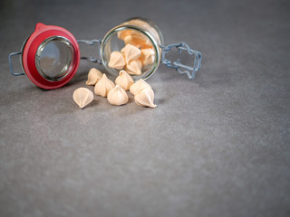 Colorful meringues in a transparent jar