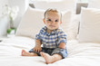 © Louis-Paul Photo - Adorable baby boy in white bedroom in morning