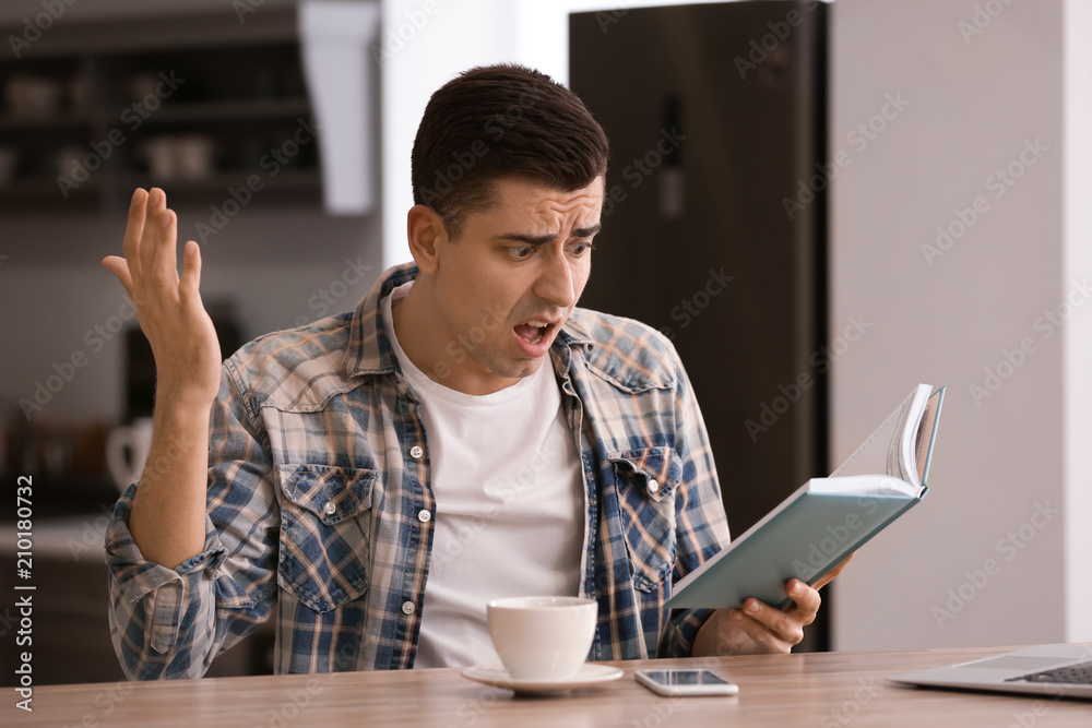 Angry freelancer with notebook at home