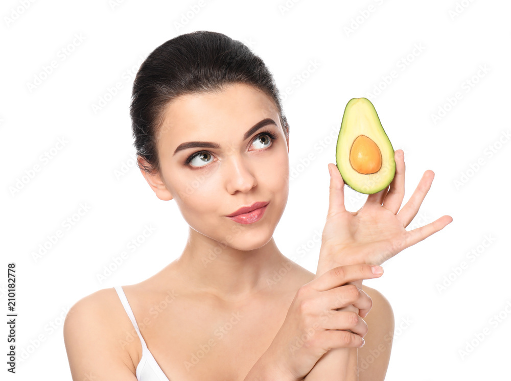 Beautiful young woman with avocado on white background