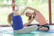 © auremar - two young girls doing back bend pose in yoga class