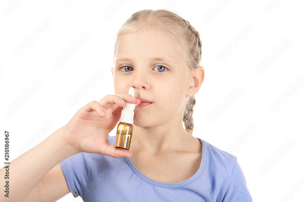 Little girl using nasal drops on white background. Allergy concept