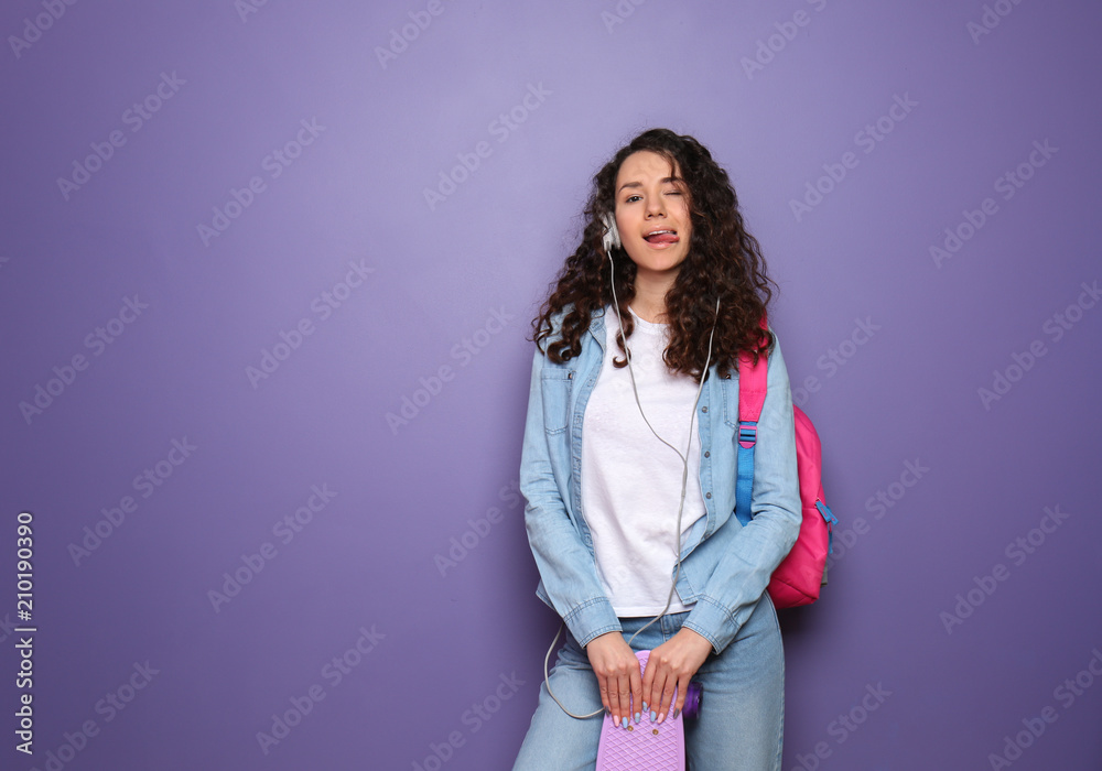 Beautiful young woman with skateboard on color background
