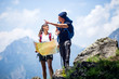 © Novak - Couple hiking with map in mountains