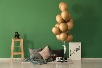 Wall Mural - Cozy place for romantic date with air balloons near color wall indoors