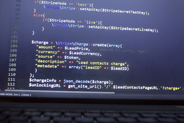 web developer php code close up. charging customer using stripe api. online payments processing. abs