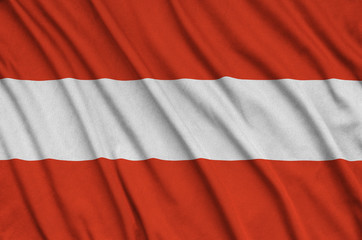 Wall Mural - Austria flag  is depicted on a sports cloth fabric with many folds. Sport team banner