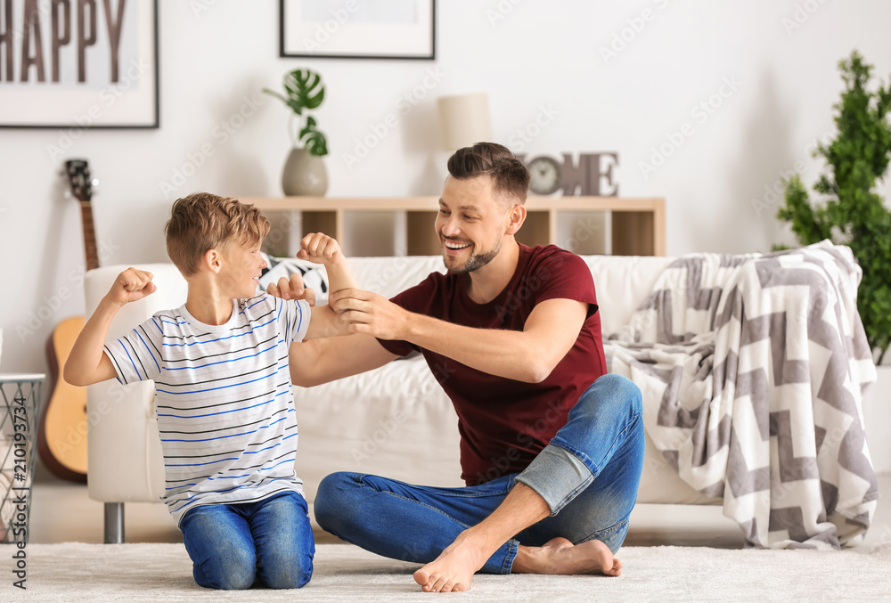 Little boy and his dad spending time together at home