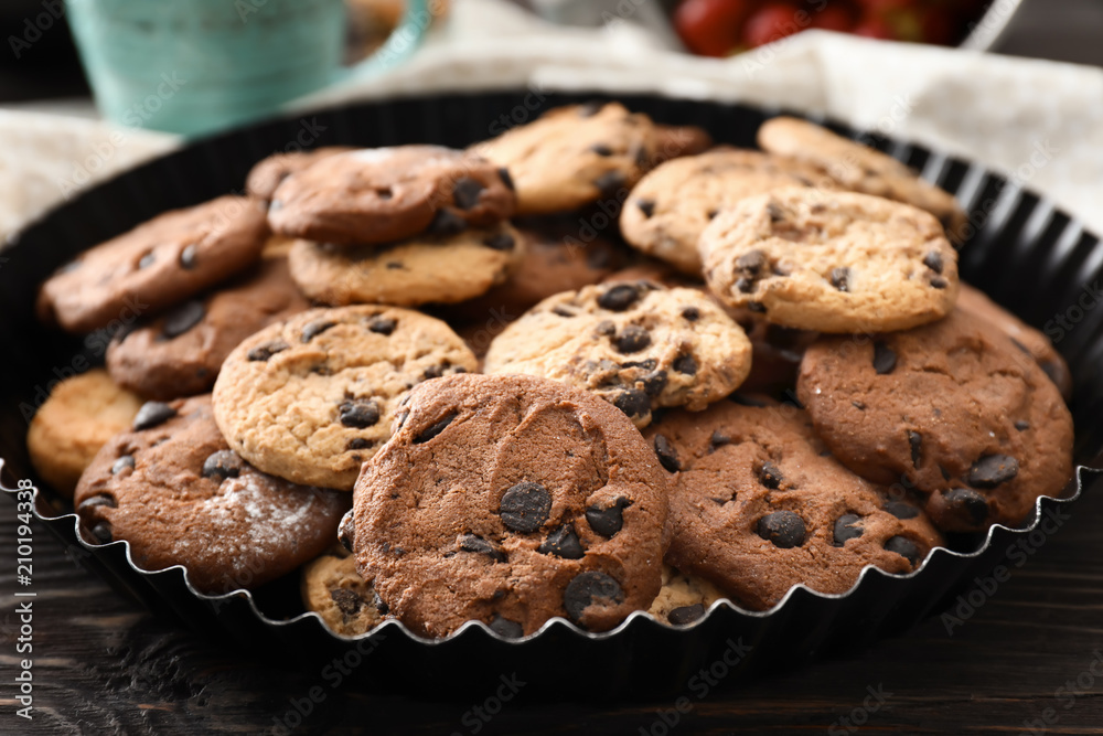 Delicious cookies with chocolate chips on table
