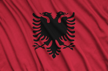 Wall Mural -  Albania flag  is depicted on a sports cloth fabric with many folds. Sport team banner