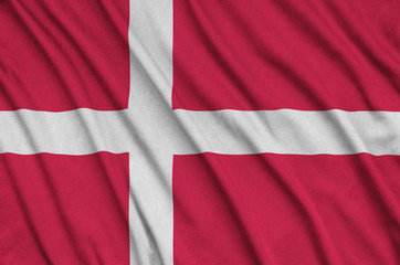 Wall Mural - Denmark flag  is depicted on a sports cloth fabric with many folds. Sport team banner