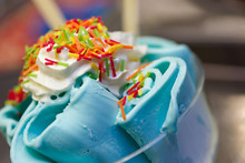 Roll Ice Cream Is Made By Hand On The Freezer. Sweet Dessert Made With Natural Colored Caramel And Blue Dye.