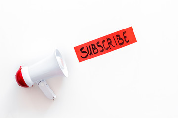 Poster - Subscribe template or mockup. Hand lettering subcribe near megaphone on white background top view space for text