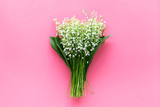 Fototapeta Lawenda - May flowers. Bouqet of lily of the valley flowers on pastel pink background top view copy space