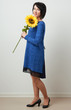 © soleg - woman with sunflower posing in blue dress