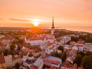 Wall Mural - beautiful orange sunset over old town of tallinn in estonia with the raekoja plats, castle and old m