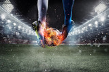 Fototapeta Sport - Soccer players with soccerball on fire at the stadium during the match