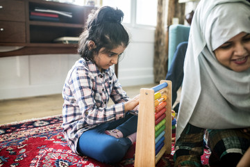 Wall Mural - Muslim family relaxing and playing at home