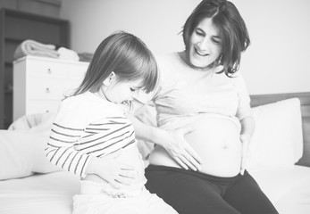 Wall Mural - Pregnant mom spending time together with her daughter