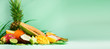 © jchizhe - Assortment of exotic fruits on turquoise background. Banner. Detox, vegan food, summer concept. Papaya, mango, pineapple, carambola, dragon fruit, kiwi, orange, melon, coconut, lime over palm leaves.