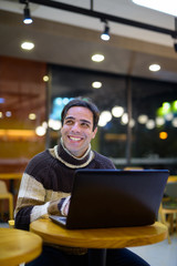 Man using laptop computer at coffee shop