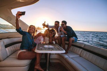 Wall Mural - Group of people taking selfie at boat party