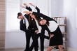 © Andrey Popov - Businesspeople Doing Exercise In Office