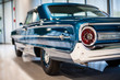© Aleksandra - Chrome rear tail lights, bumper and exhaust of convertible turquoise vintage car
